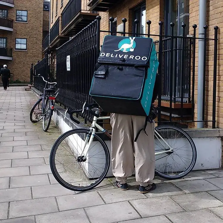 A Deliveroo cyclist in London, UK